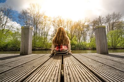 Girl sitting on a bridge